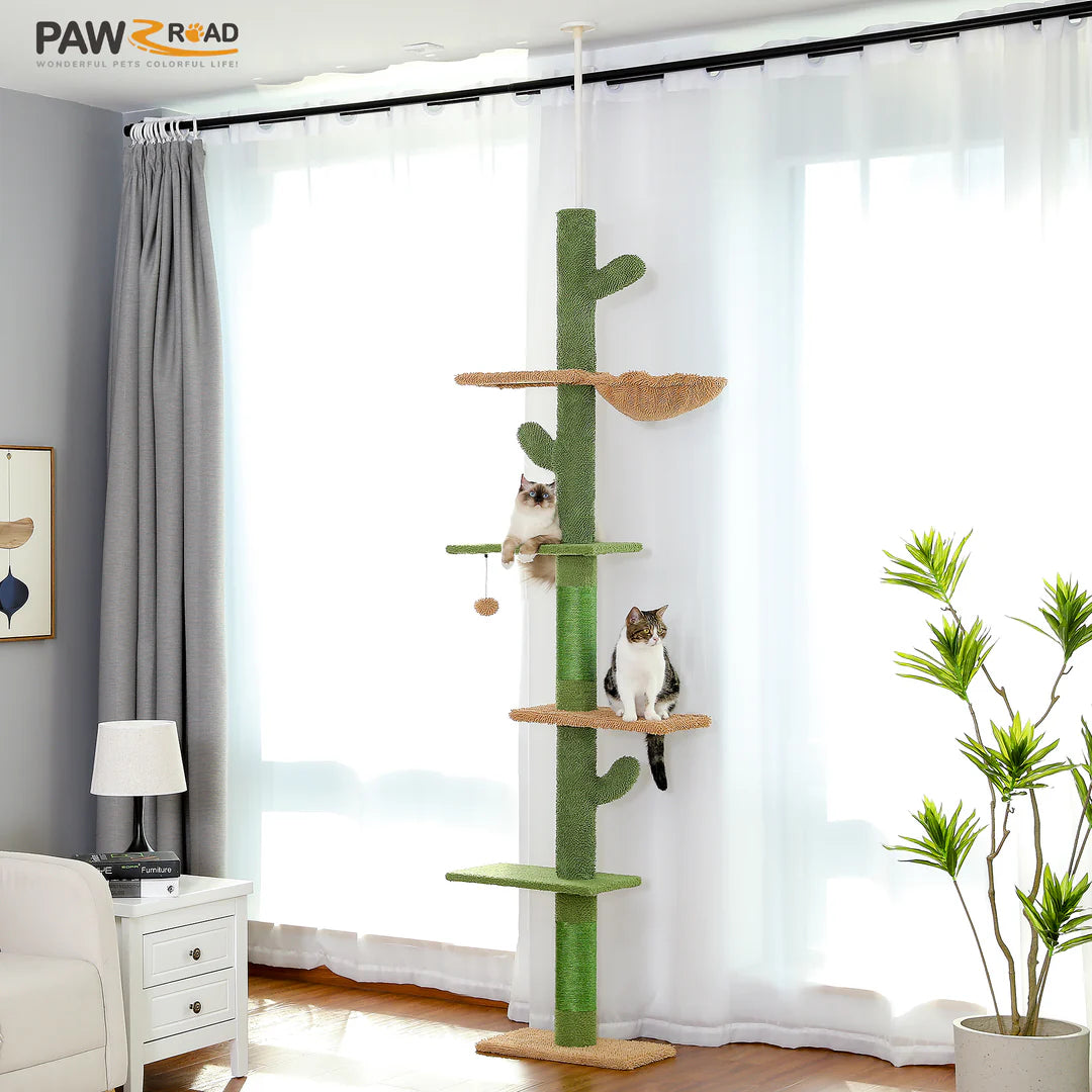 Cat tree with multiple levels in a room with curtains and a plant