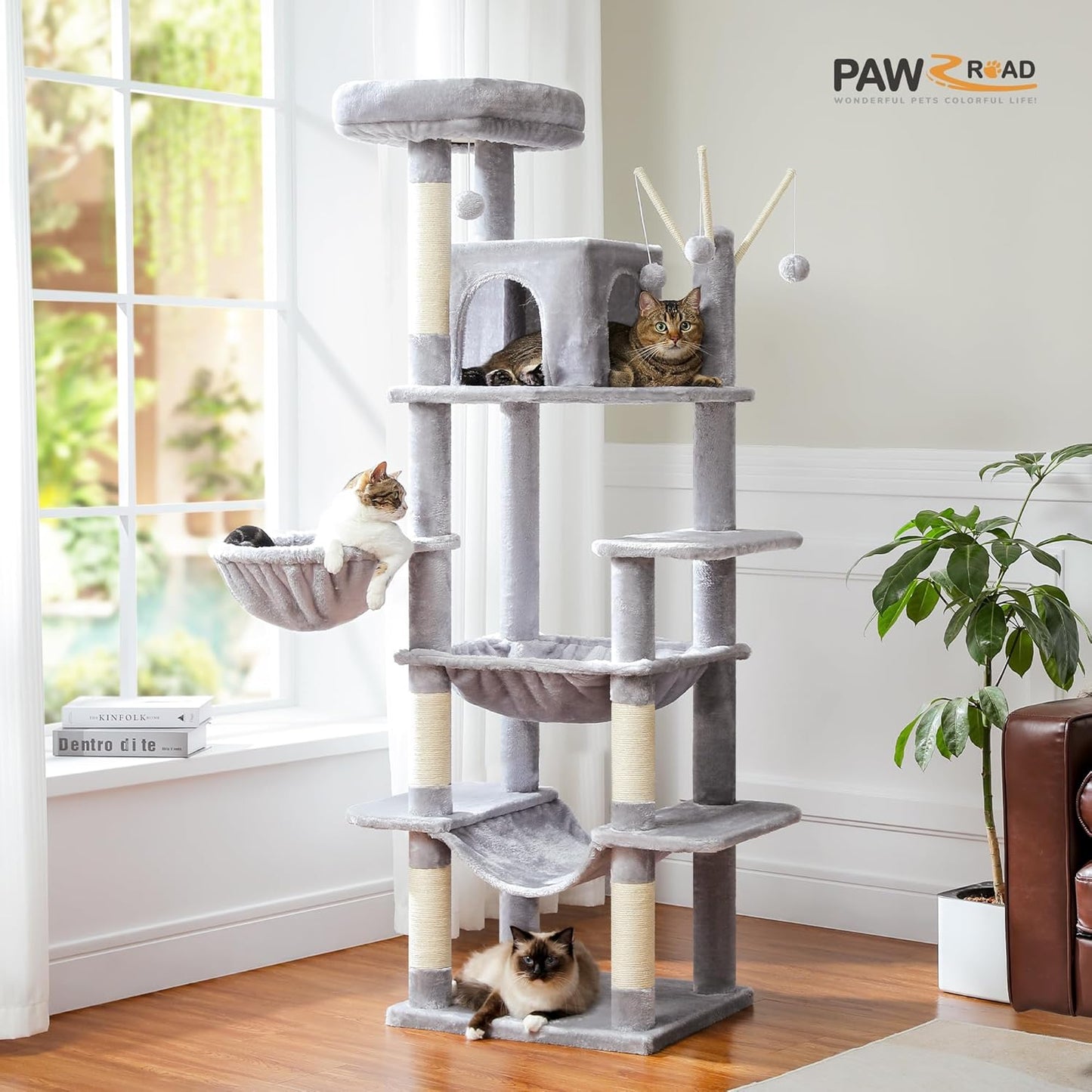 Cat tree with multiple levels and a cat sitting on top in a room with a window and plant.