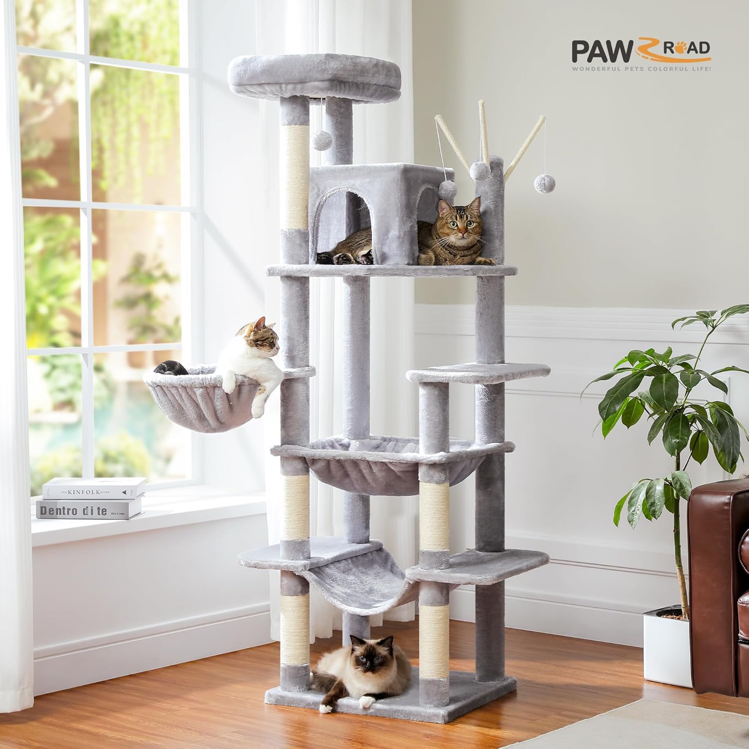 Cat tree with multiple levels and a cat sitting on top in a room with a window and plant.