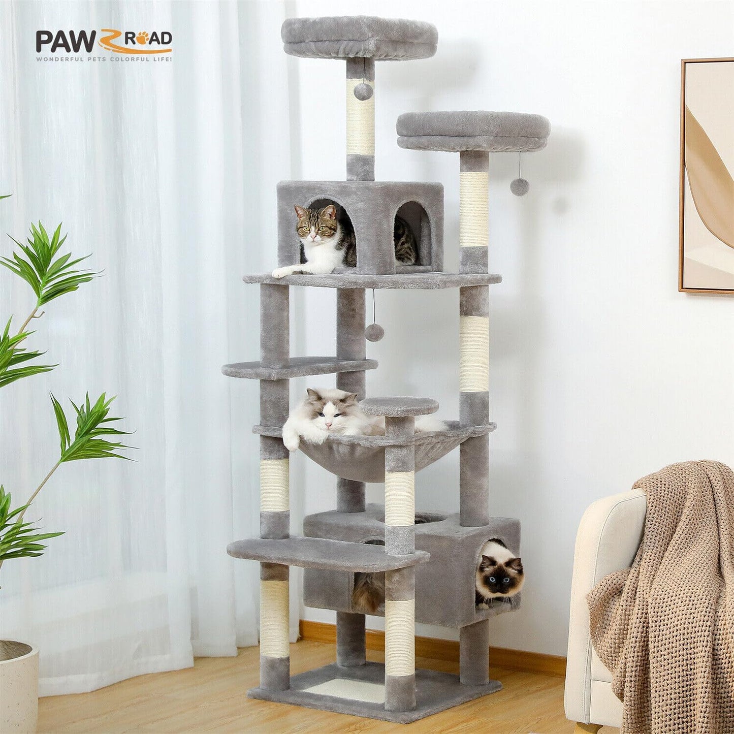 Cat tree with multiple levels and a cat sitting on top in a room with a plant and chair.