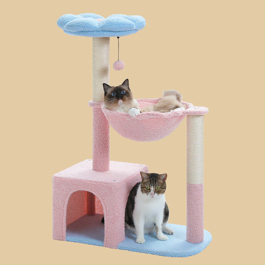 Cat tree with pink cushion, blue platform, and hammock on a beige background